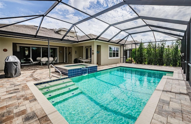 view of swimming pool featuring an in ground hot tub, a patio area, and a lanai