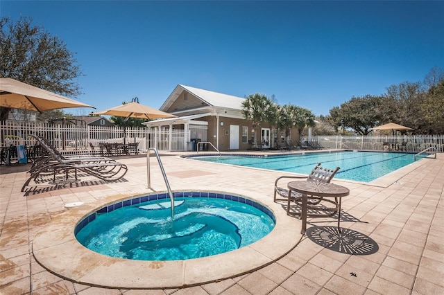 view of pool featuring a community hot tub and a patio area