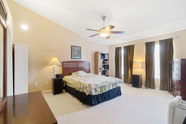 carpeted bedroom with ceiling fan and vaulted ceiling