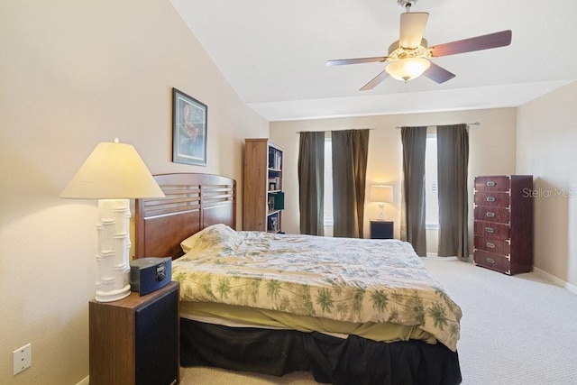 bedroom featuring light carpet, vaulted ceiling, and ceiling fan