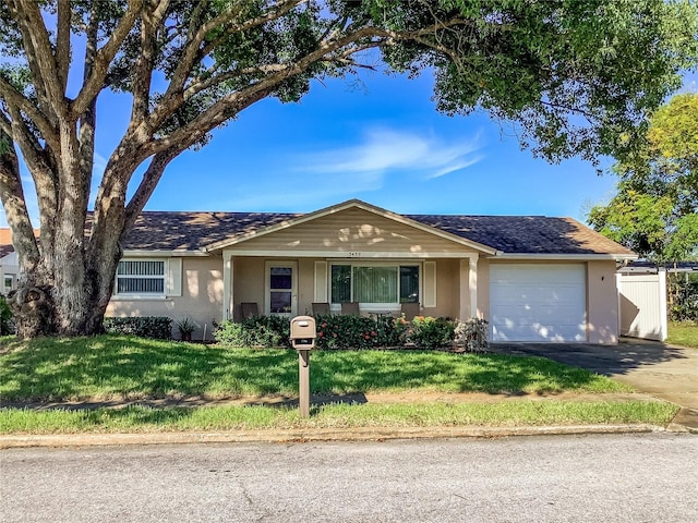 single story home featuring a garage and a front lawn