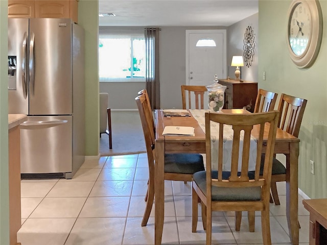 dining area featuring light tile patterned flooring