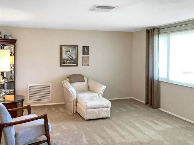 sitting room with light colored carpet