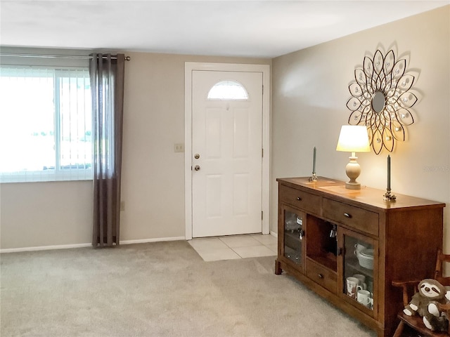 foyer featuring light carpet