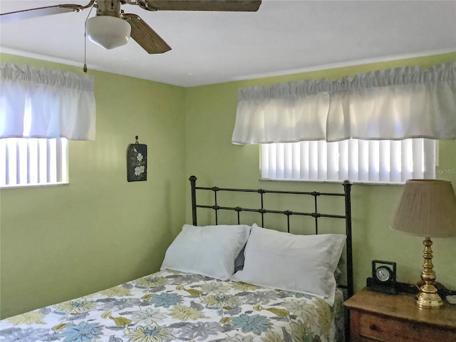 bedroom featuring multiple windows and ceiling fan