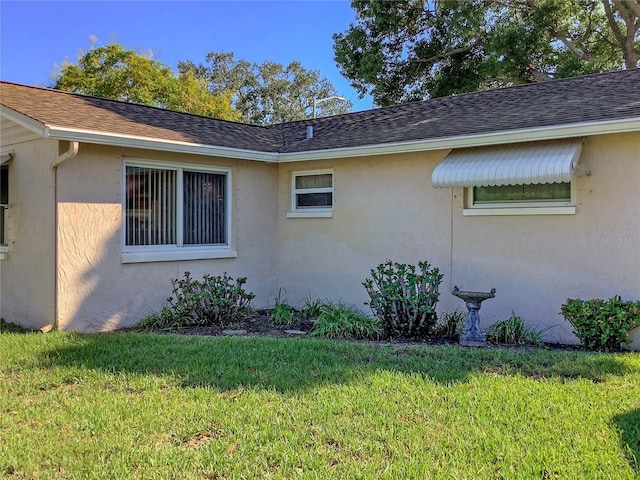 view of property exterior with a yard