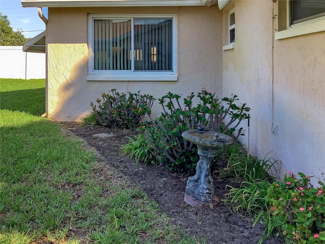 view of property exterior with a lawn