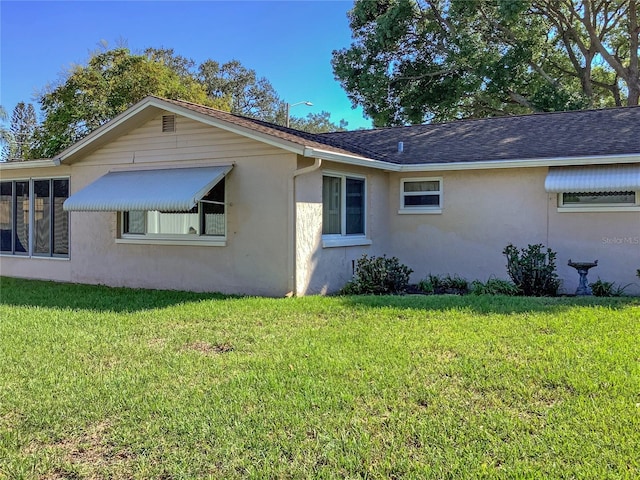 view of home's exterior with a yard