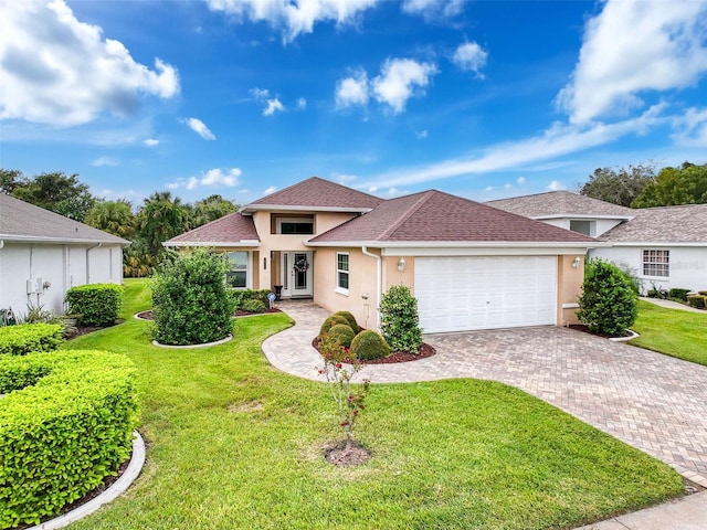 view of front of home with a garage and a front lawn