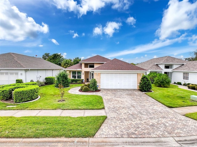 ranch-style house featuring a garage and a front lawn