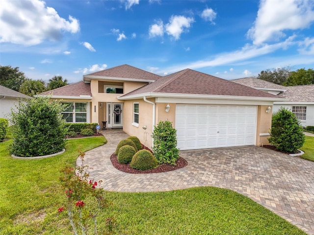 view of front facade with a front yard and a garage