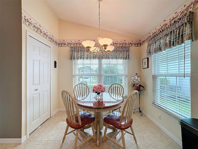 dining room with light tile patterned floors, lofted ceiling, and a wealth of natural light