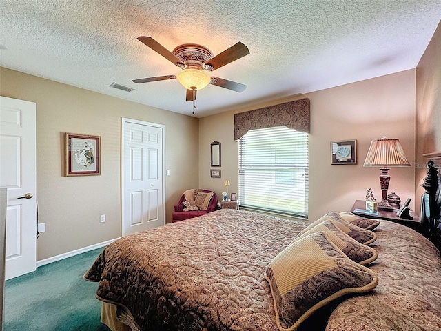 carpeted bedroom featuring a closet, a textured ceiling, and ceiling fan