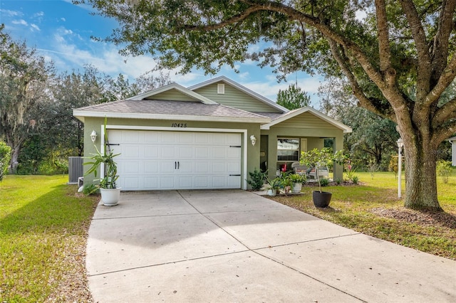 view of front of home with a front yard and a garage