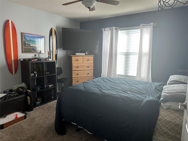 carpeted bedroom featuring a textured ceiling and ceiling fan