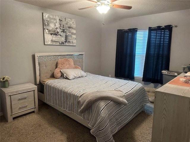 bedroom featuring ceiling fan, carpet floors, and a textured ceiling