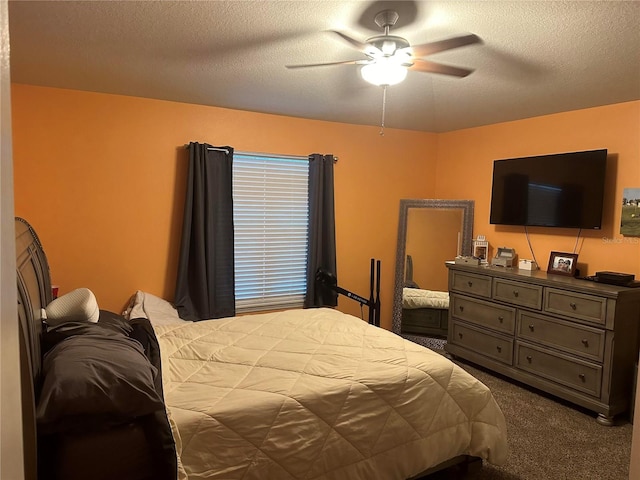 carpeted bedroom with ceiling fan and a textured ceiling