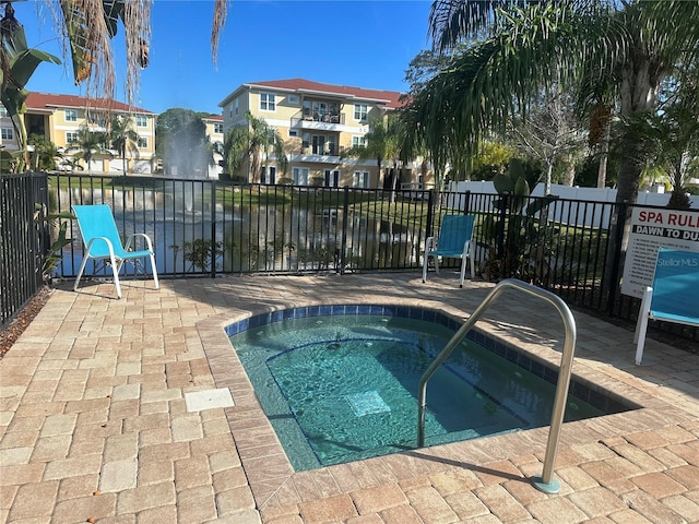 view of pool with a water view and a community hot tub