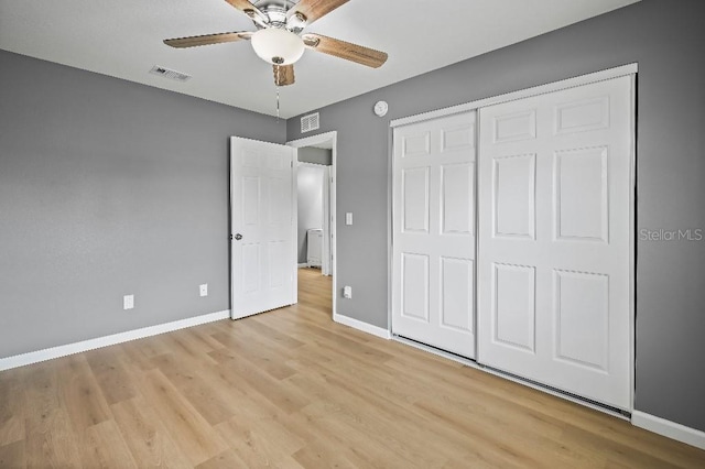 unfurnished bedroom featuring light wood-type flooring, a closet, and ceiling fan