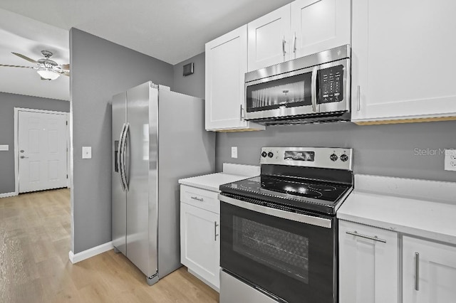 kitchen with white cabinets, appliances with stainless steel finishes, light hardwood / wood-style flooring, and ceiling fan