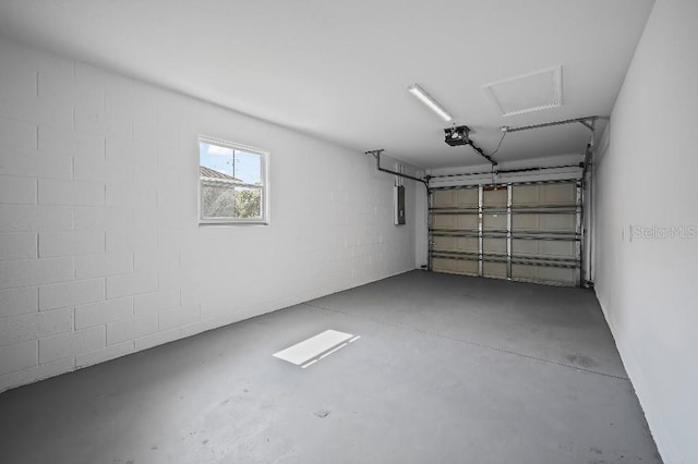 garage with a garage door opener and electric panel