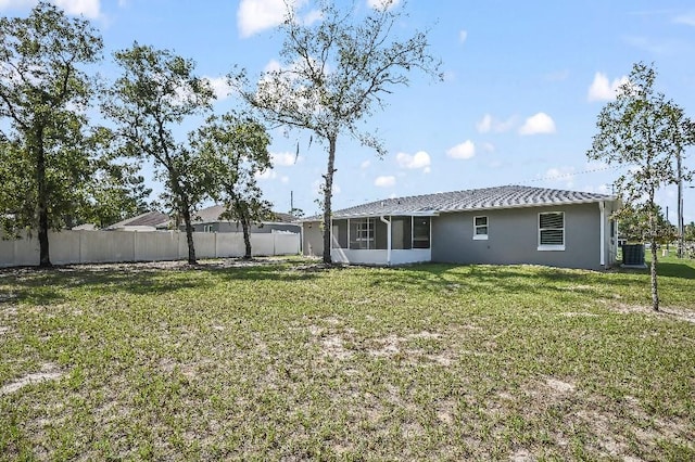 view of yard featuring central AC and a sunroom