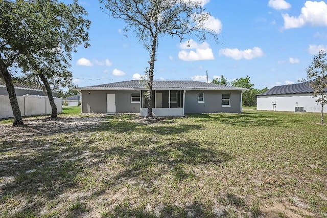 rear view of house with a yard