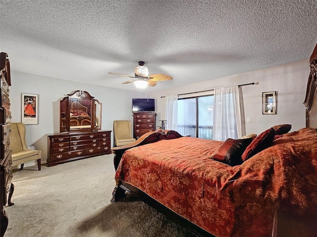 bedroom with a textured ceiling, carpet, and a ceiling fan