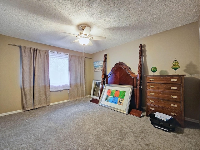 unfurnished bedroom featuring a textured ceiling, carpet flooring, baseboards, and ceiling fan