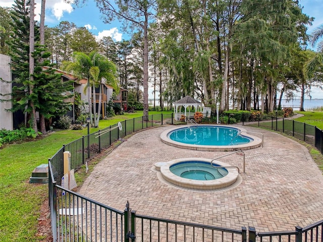 view of swimming pool featuring a gazebo, an in ground hot tub, a yard, and a patio