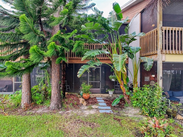 exterior space with a sunroom and a balcony