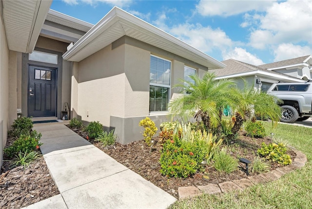 view of exterior entry with a garage