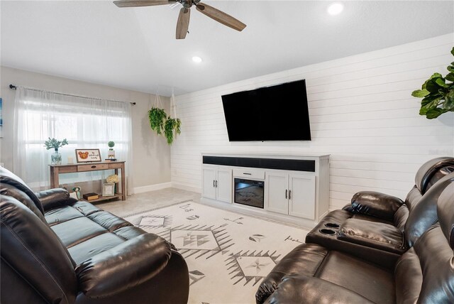 carpeted living room with ceiling fan