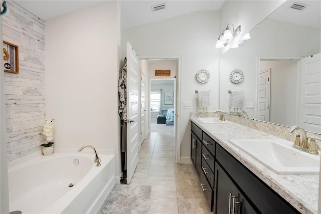 bathroom featuring lofted ceiling, wooden walls, a tub, and vanity