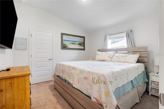 bedroom featuring lofted ceiling and light carpet