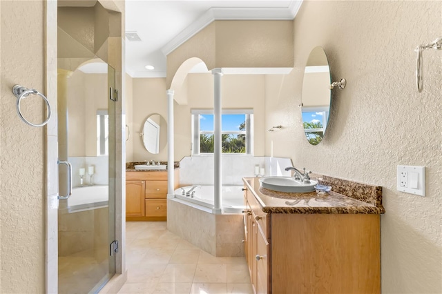 bathroom with ornamental molding, separate shower and tub, vanity, and ornate columns