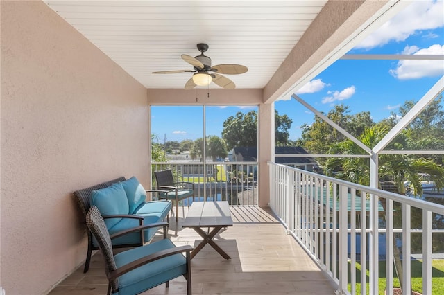 sunroom featuring ceiling fan