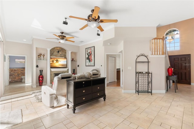 living room featuring ornamental molding, ceiling fan, and built in features