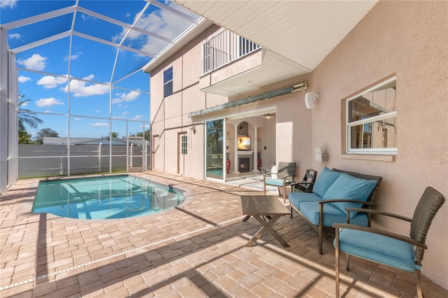 view of swimming pool featuring a lanai and a patio area