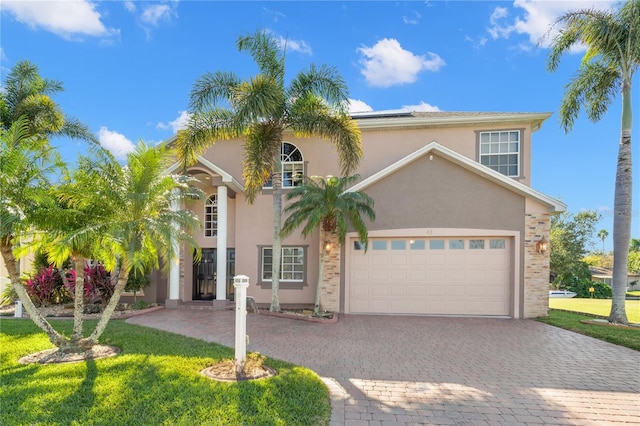 mediterranean / spanish house with a garage and a front yard