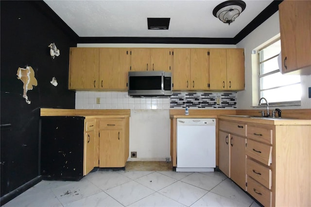 kitchen featuring white dishwasher, crown molding, sink, and decorative backsplash