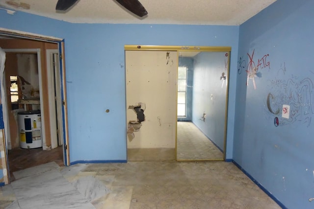 hallway featuring a textured ceiling and water heater