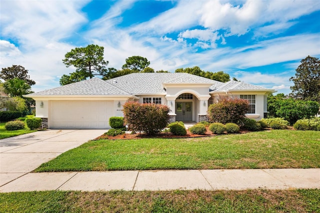 view of front of house with a front yard and a garage