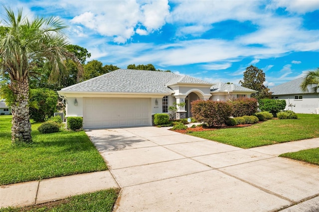 view of front of house with a garage and a front lawn