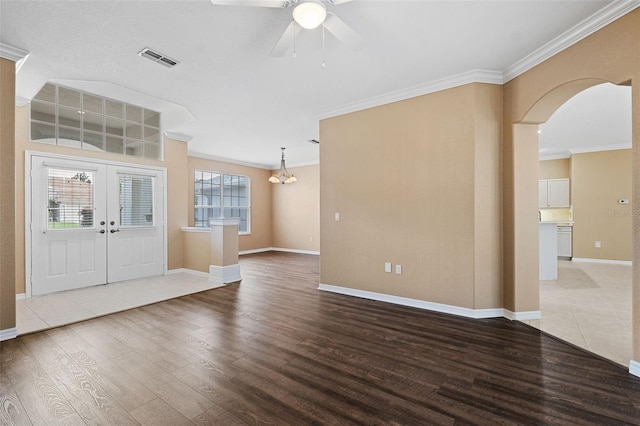 foyer featuring plenty of natural light, hardwood / wood-style flooring, and crown molding