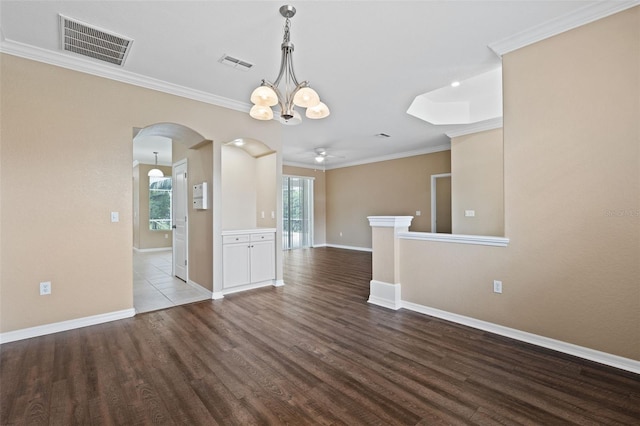 unfurnished dining area featuring ceiling fan with notable chandelier, wood-type flooring, and ornamental molding