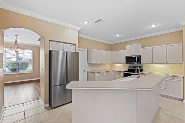 kitchen featuring appliances with stainless steel finishes, white cabinets, crown molding, a center island with sink, and sink