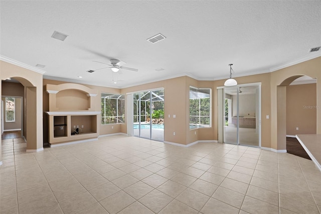 unfurnished living room featuring ceiling fan, plenty of natural light, and crown molding