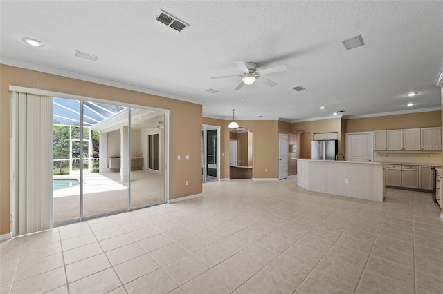 unfurnished living room featuring ceiling fan, a textured ceiling, crown molding, and light tile patterned floors