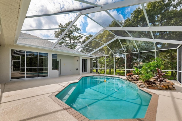 view of swimming pool with a lanai and a patio